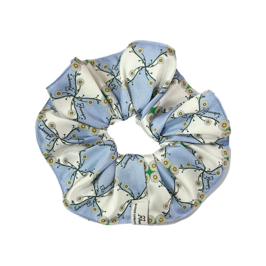 A blue and white floral pattern silky hair scrunchie.