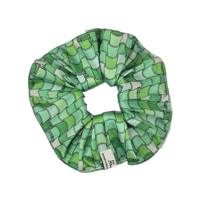 A green geometric patterned hair scrunchie.
