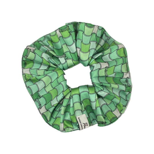 A green geometric patterned hair scrunchie.