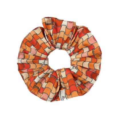 A terracotta tiles patterned hair scrunchie displayed on a white background.